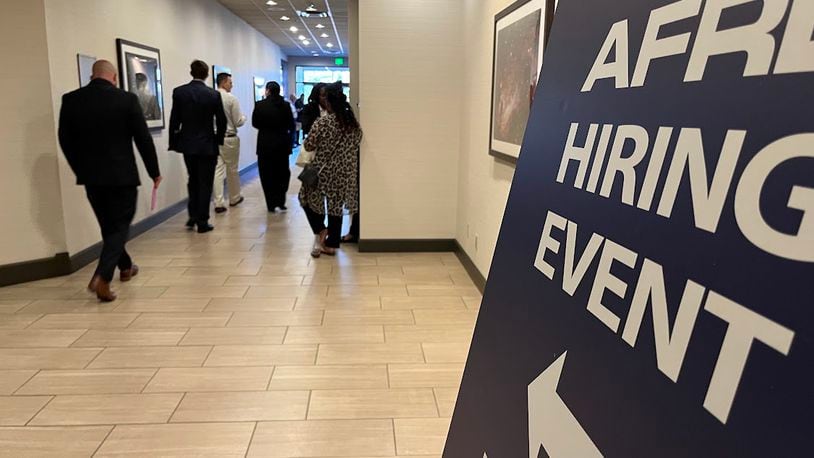 Applicants walk to the Air Force Research Laboratory hiring event Tuesday at the Fairborn Holiday Inn. THOMAS GNAU/STAFF