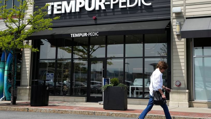 FILE - A passer-by walks near the front of a Tempur-Pedic mattress store location, May 9, 2023, in Dedham, Mass. The Federal Trade Commission has unanimously voted to bring a lawsuit against mattress maker Tempur Sealy to block its $4 billion acquisition of Mattress Firm, saying the deal would allow the world’s largest mattress supplier to suppress competition that would result in higher prices for shoppers. (AP Photo/Steven Senne, File)