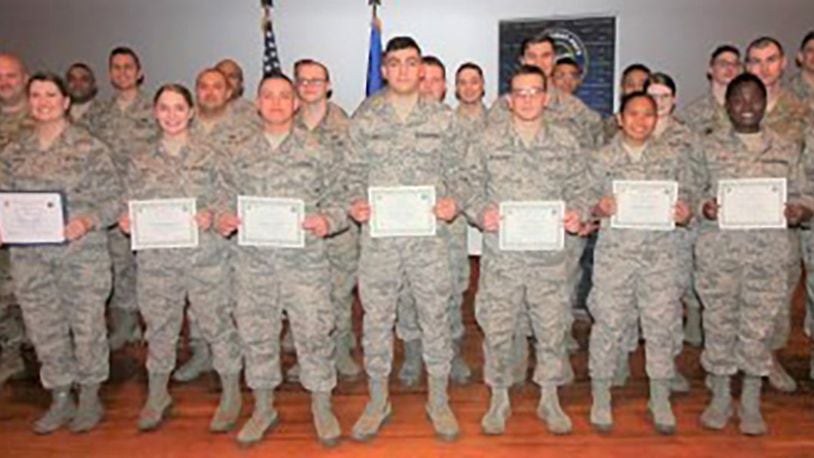 Col. Tom Sherman (left), 88th Air Base Wing and installation commander, and Chief Master Sgt. Stephen Arbona (back right), 88th Air Base Wing command chief, celebrate the newest Team Wright-Patt enlisted promotees during a ceremony at the Wright-Patterson Base Theater, Jan. 31. (U.S. Air Force photo/Thomas Lewis)