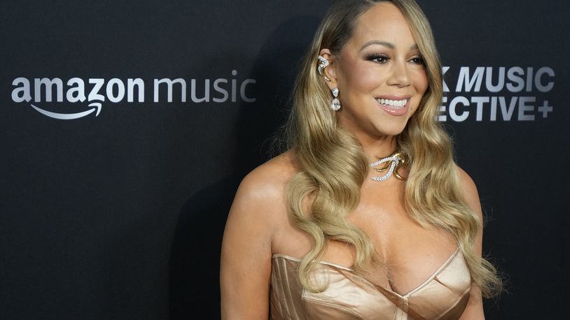FILE - Mariah Carey arrives at the third annual Recording Academy Honors Presented by The Black Music Collective in Los Angeles on Feb. 1, 2024. Big record companies are suing artificial intelligence song generators Suno and Udio for copyright infringement, alleging that the AI music startups are exploiting the copyrighted works of artists from Carey to Chuck Berry. (AP Photo/Damian Dovarganes, File)