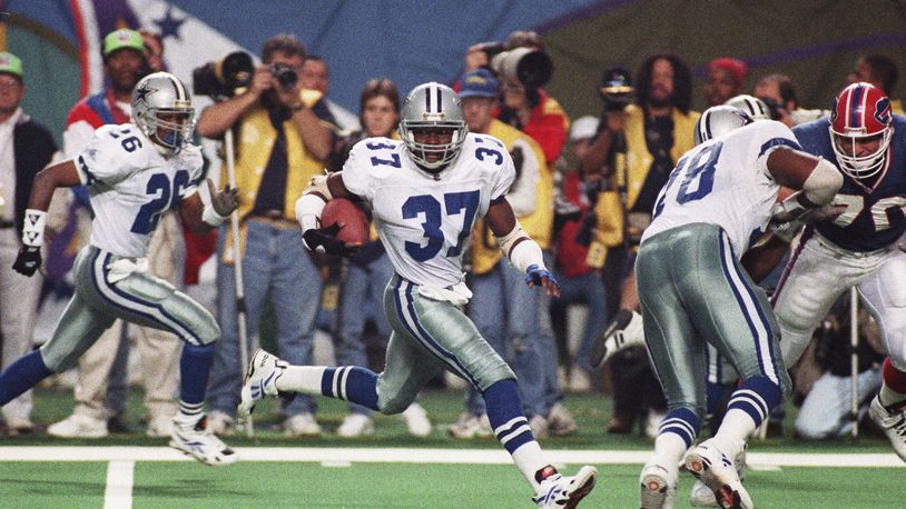 FILE - Dallas Cowboys safety James Washington (37) sprints to a touchdown after Buffalo Bills' Thurman Thomas fumbled the ball during third quarter action at Super Bowl XXVIII in the Georgia Dome in Atlanta, Jan. 30, 1994. Washington recovered the fumble and ran 46 yards for the tying touchdown in the second half. (AP Photo/Doug Mills, File)