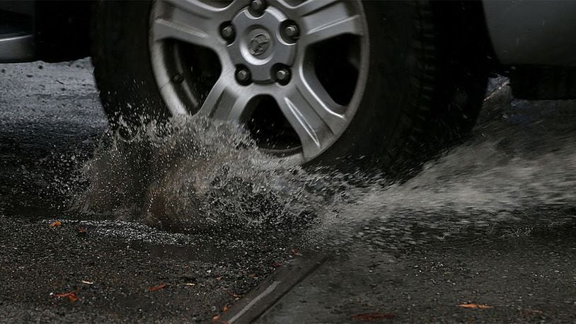 FILE PHOTO: A massive pothole in a New Orleans street injured a disabled woman in her 70s after she tipped over in her wheelchair, falling into a water-filled hole.