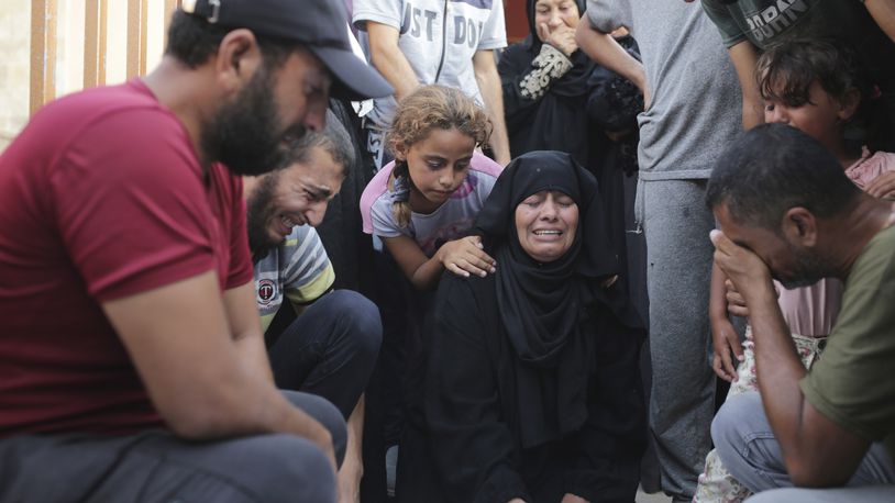 A Palestinian family mourns a loved one killed by Israeli bombardment , as they take a last look before their funeral in Khan Younis, southern Gaza Strip, Friday, June 21, 2024. (AP Photo /Jehad Alshrafi)