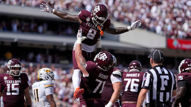 Texas A&M running back Le'Veon Moss (8) celebrates with teammate Chase Bisontis (71) after he scored a touchdown against Missouri during the first half of an NCAA college football game Saturday, Oct. 5, 2024, in College Station, Texas. (AP Photo/Eric Gay)