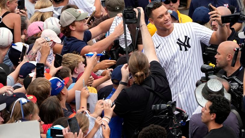 New York Yankees' Aaron Judge takes a selfie with a fan's cell phone as he arrives with the New York Yankees arrive at the Little League World Series Complex to watch the Little League World Series tournament in South Williamsport, Pa., Sunday, Aug. 18, 2024. (AP Photo/Tom E. Puskar)