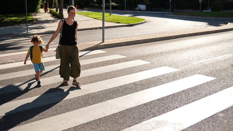 Mother and her son crossing road on way to school. Pedestrian safety remains a concern among traffic safety advocates. ROBERTO JIMENEZ/ISTOCK