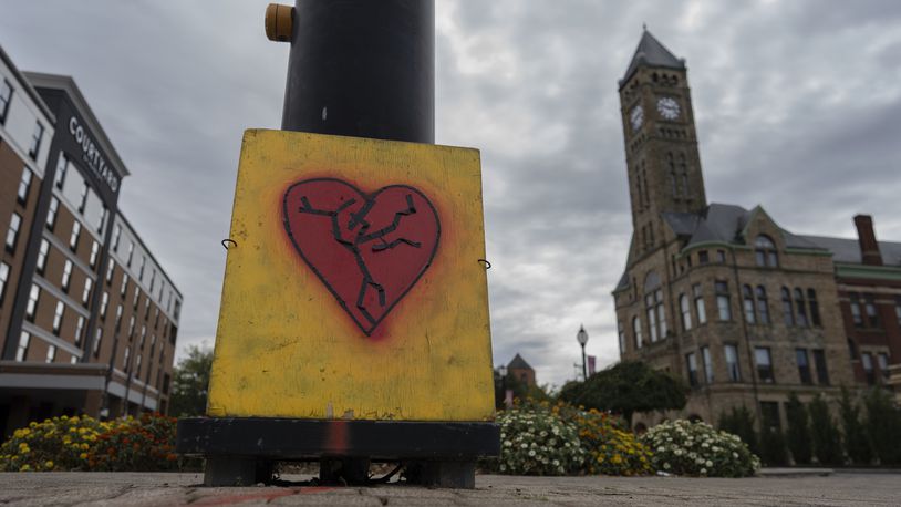 An image of a broken heart is fixed across the street from City Hall with the Heritage Center of Clark County, right, Tuesday, Sept. 17, 2024, in Springfield, Ohio. (AP Photo/Carolyn Kaster)