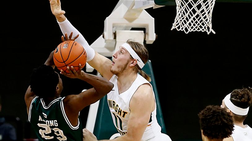 Wright State center Loudon Love blocks the shot of Green Bay forward Emmanuel Ansong during a men's basketball game at the Nutter Center in Fairborn Saturday, Dec. 26, 2020. E.L. Hubbard/CONTRIBUTED