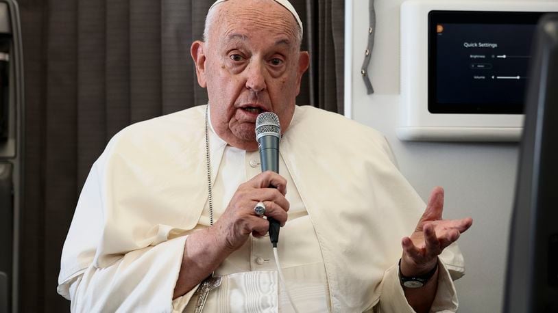 Pope Francis holds a news conference aboard the papal plane on his flight back after his 11-day journey across Southeast Asia and Oceania, Friday, Sept. 13, 2024. Francis went rogue plenty of times in Asia, and at the in-flight press conference coming back to Rome, he urged American Catholics to vote for who they thought was the "lesser evil" for president. (Guglielmo Mangiapane/Pool Photo via AP)