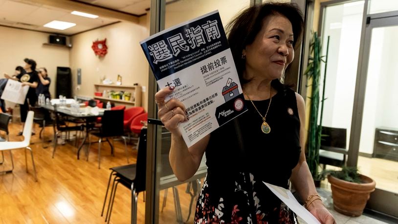 Vida Lin, president and founder of the Asian Community Development Council, holds a voter information booklet her group translated into Chinese during the annual Dragon Boat Festival in Las Vegas, Wednesday, June 5, 2024. (Christopher Lomahquahu/News21 via AP)