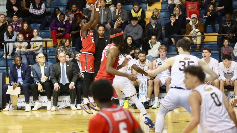 Dayton's Kobe Elvis makes a 3-pointer against La Salle on Tuesday, Jan. 23, 2024, at Tom Gola Arena in Philadelphia. David Jablonski/Staff