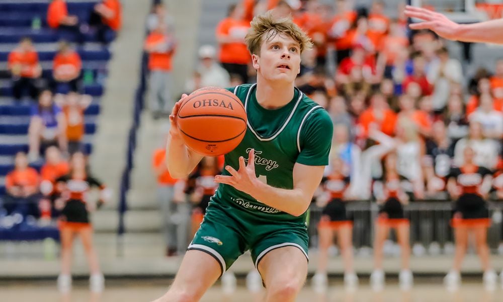 Troy Christian's Christian Brusman drives through the lane during a Division IV regional semifinal game against Jackson Center on Tuesday night at Trent Arena in Kettering. Michael Cooper/CONTRIBUTED