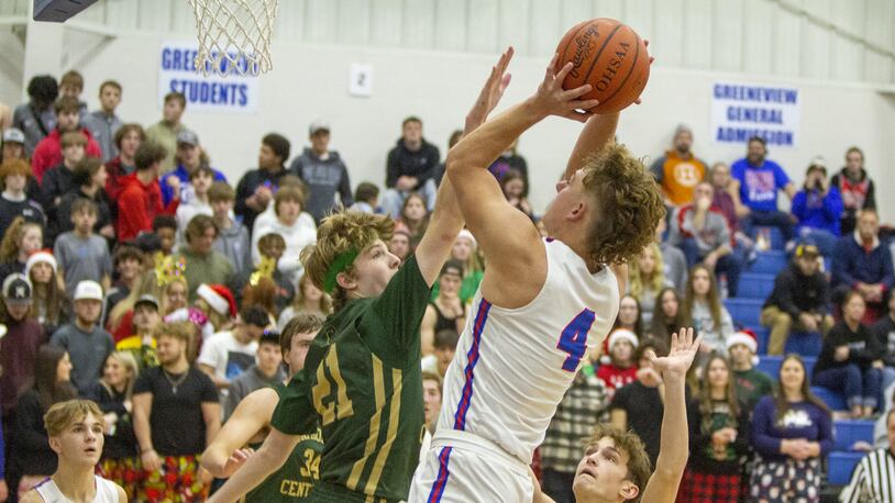 Greeneview's Carter Williams shoots over Catholic Central's Ben Bramel during Friday's game. Williams led all scorers with 24 points. CONTRIBUTED/Jeff Gilbert