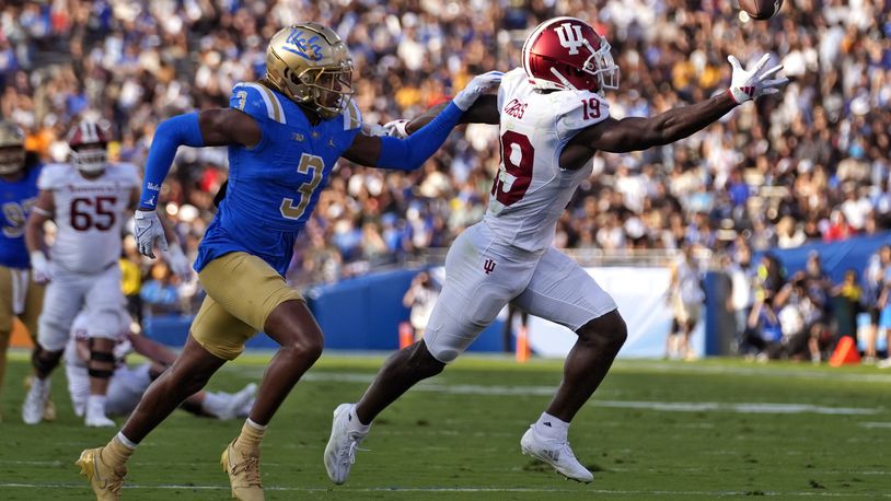 Indiana wide receiver Miles Cross, right, makes a catch on a pass as UCLA defensive back Devin Kirkwood defends during the first half of an NCAA college football game, Saturday, Sept. 14, 2024, in Pasadena, Calif. (AP Photo/Mark J. Terrill)