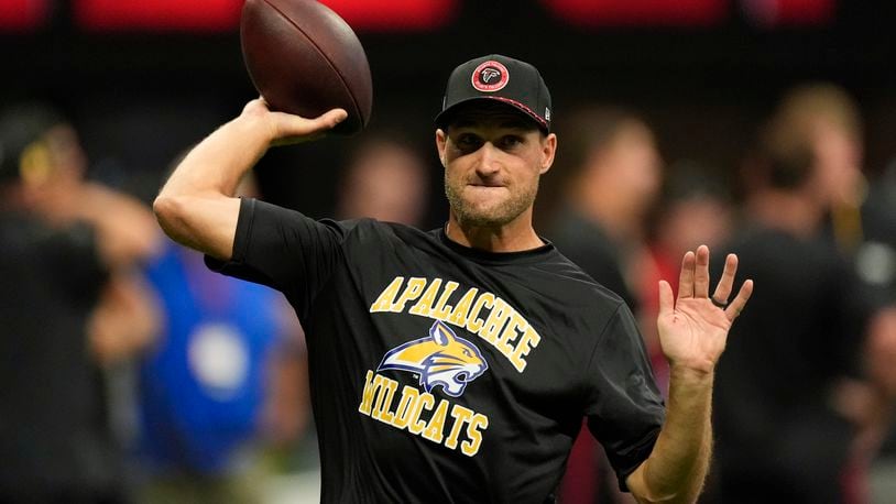 Atlanta Falcons quarterback Kirk Cousins warms up, while wearing an Apalachee High School T-shirt following a recent school shooting there, before an NFL football game against the Pittsburgh Steelers on Sunday, Sept. 8, 2024, in Atlanta. (AP Photo/John Bazemore)