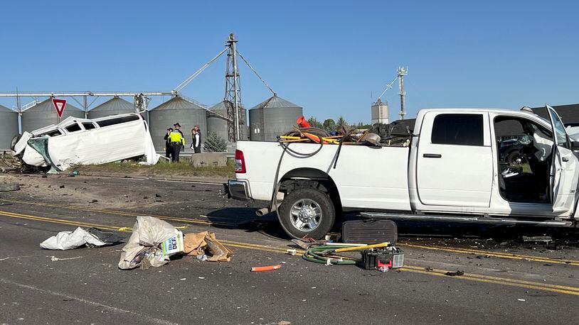 In this photo provided by KIFI Local News 8, a pickup truck crashed into a passenger van on U.S. Highway 20, Saturday, May 18, 2024, in Idaho Falls, Idaho. State police say the accident happened early Saturday morning when a pickup crossed the centerline on U.S. Highway 20 and fatally hit a passenger van. (Jeff Roper/KIFI Local News 8 via AP)