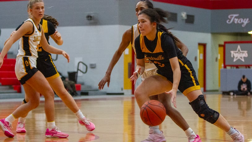 Centerville point guard Kaitlyn Palomino drives past Sidney's Kellis McNeal during Wednesday night's Division I tournament game at Troy High School. Jeff Gilbert/CONTRIBUTED