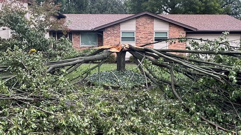 A tree at a home on Hyde Park Drive in Centerville was split into two Friday night, Sept. 27, 2024 after winds from remnants of Hurricane Helene swept through the area. Jeremy Kelley/Staff photo