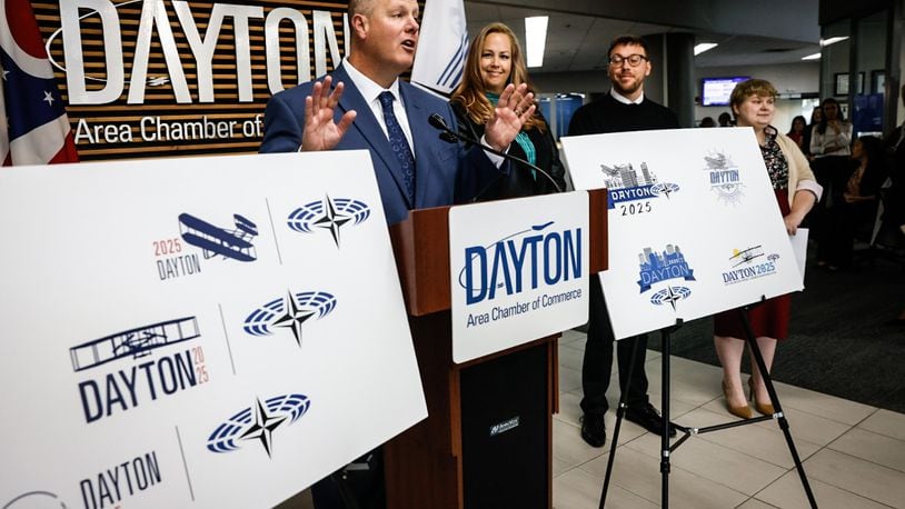 From left, President and CEO of the Dayton Area Chamber of Commerce Chris Kershner Graphic Designers Kim Swigart, Josh Trippier and Elizabeth Kimmel showoff their NATO Spring Parliamentary Assembly logos at the Dayton Area Chamber of Commerce offices on Main Street Wednesday October 9, 2024. JIM NOELKER/STAFF