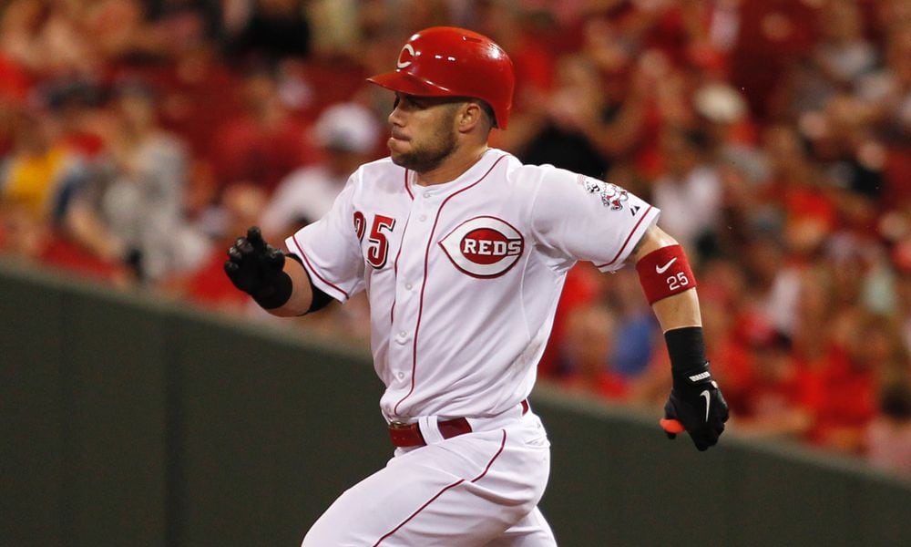 The Reds' Skip Schumaker heads to second with a double in the fifth inning Monday, July 7, 2014, at Great American Ball Park in Cincinnati.