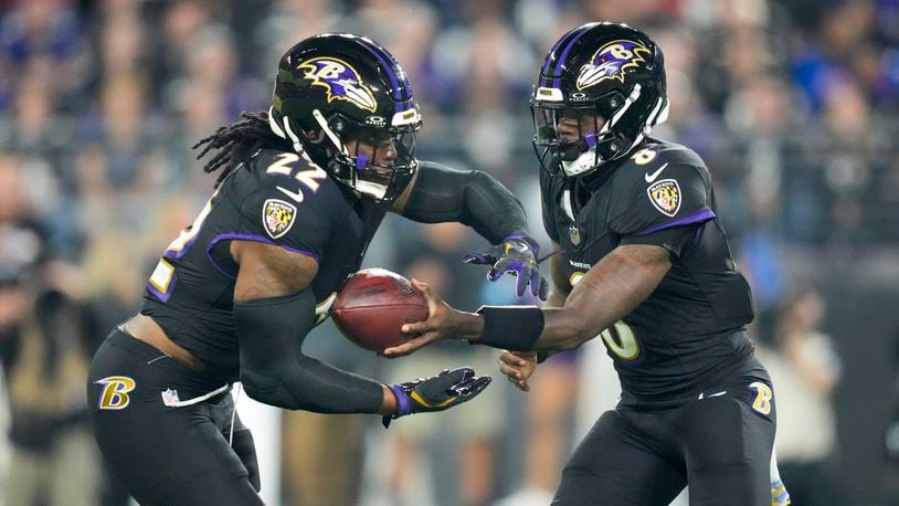 Baltimore Ravens running back Derrick Henry, left, takes a handoff from quarterback Lamar Jackson while running for a long touchdown against the Buffalo Bills during the first half of an NFL football game, Sunday, Sept. 29, 2024, in Baltimore. (AP Photo/Stephanie Scarbrough)