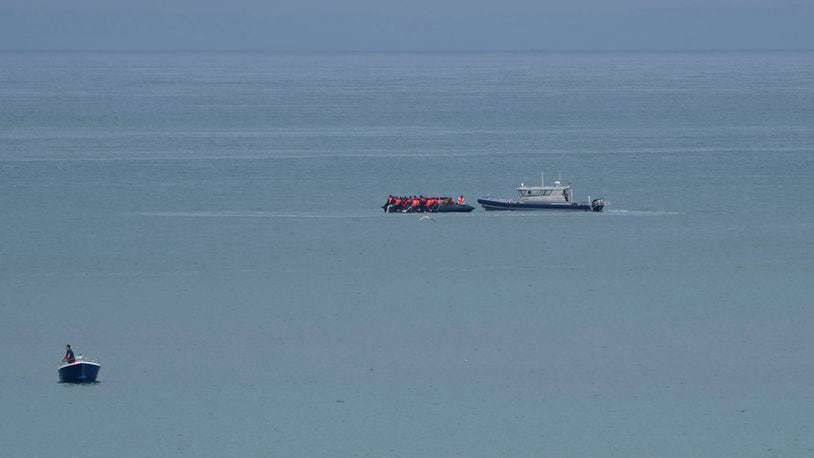 A boat thought to be with migrants is escorted by a vessel from the French Gendarmerie Nationale off the Wimereux beach, France, Wednesday, Sept. 4, 2024. A boat carrying migrants ripped apart in the English Channel as they attempted to reach Britain from northern France on Tuesday, plunging dozens into the treacherous waterway and leaving 12 dead, authorities said. (AP Photo/Nicolas Garriga)