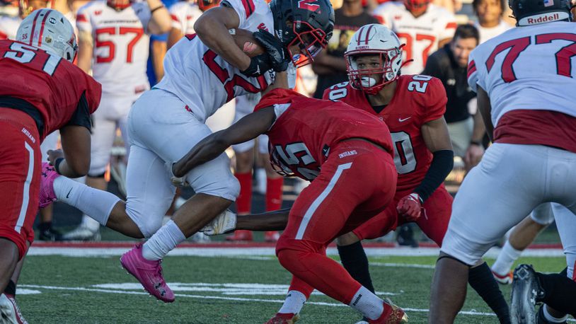 Lakota West's Braydon Johnson (22) is tackled by Fairfield's Raymir Coney (25) on Friday night. Erik Nett/CONTRIBUTED