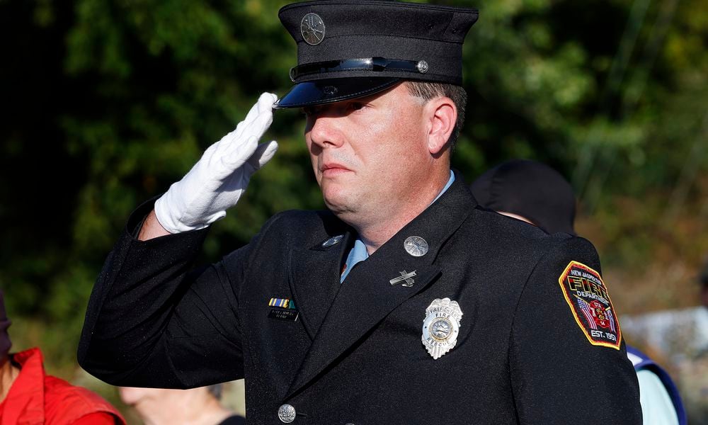 New Jasper Twp. Firefighter Larry Trusty paid his respects to the victims of 9/11 Wednesday, Sept. 11, 2024 at the Beavercreek 9/11 Memorial Ceremony. MARSHALL GORBY\STAFF