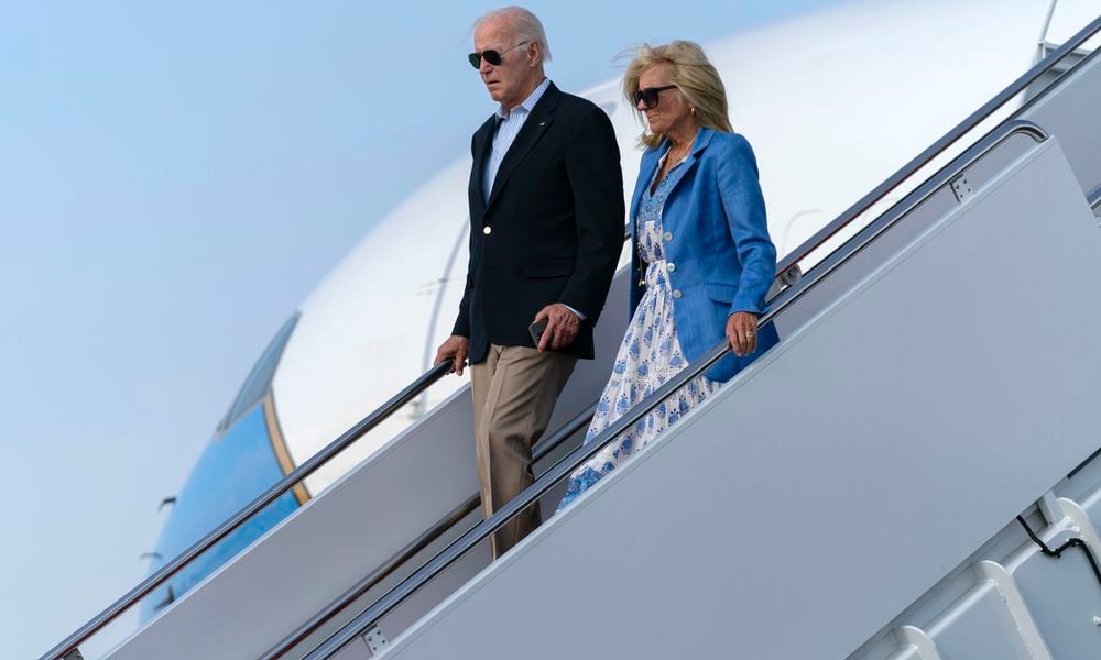 President Joe Biden, left, and first lady Jill Biden walk down the stairs of Air Force One upon arrival to Joint Base Andrews, Md., en route to the White House, Sunday, Aug. 18, 2024. (AP Photo/Jose Luis Magana)