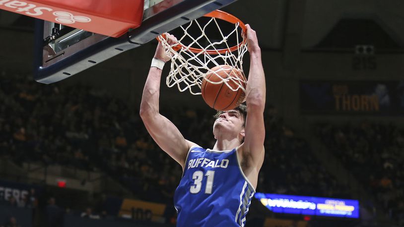 Buffalo center Isaac Jack dunks against West Virginia during the first half of an NCAA college basketball game in Morgantown, W.Va., Sunday, Dec. 18, 2022. (AP Photo/Kathleen Batten)