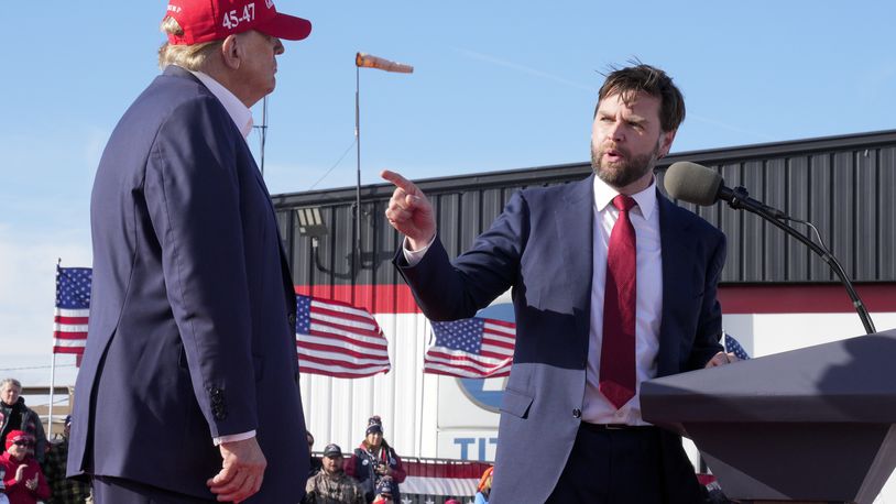 FILE - Sen. J.D. Vance, R-Ohio, right, points toward Republican presidential candidate former President Donald Trump at a campaign rally on March 16, 2024, in Vandalia, Ohio. Vance sharply criticized Trump during the 2016 election cycle, before changing course and embracing the former president. Vance is now one of Trump's fiercest allies and defenders and among those short-listed to be Trump's vice presidential pick. AP Photo/Jeff Dean, File)