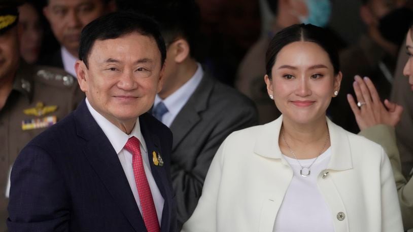 FILE - Thailand's former Prime Minister Thaksin Shinawatra, left, with, his daughter Paetongtarn, arrives at Don Muang airport in Bangkok, Thailand, Tuesday, Aug. 22, 2023.(AP Photo/Sakchai Lalit, File)