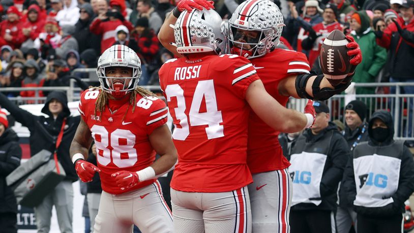 Ohio State tight end Cade Stover, right, celebrates one of his touchdowns against Indiana with teammate tight end Mitch Rossi, center, and tight end Gee Scott during the second half of an NCAA college football game Saturday, Nov. 12, 2022 in Columbus, Ohio. Ohio State won 56-14. (AP Photo/Paul Vernon)