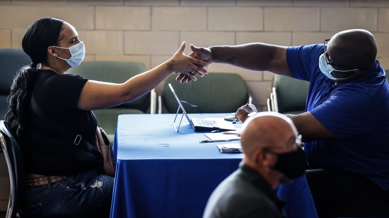 Mary Johnson shakes hands with Dayton Public Schools Human Resources partner Andrae Hicks Wednesday, Sept. 29, 2021 after a job interview.  Dayton Public Schools held a job fair at the Jackson Center on Abbey Ave.  JIM NOELKER/STAFF