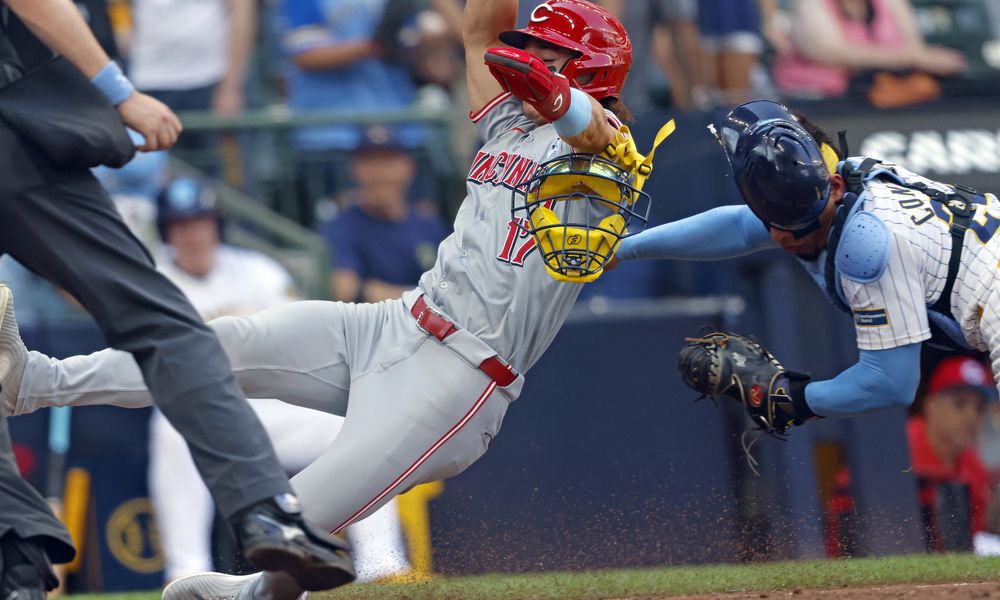 Milwaukee Brewers' William Contreras, right, tags out Cincinnati Reds' Stuart Fairchild (17) during the ninth inning of a baseball game Sunday, June 16, 2024, in Milwaukee. (AP Photo/Jeffrey Phelps)