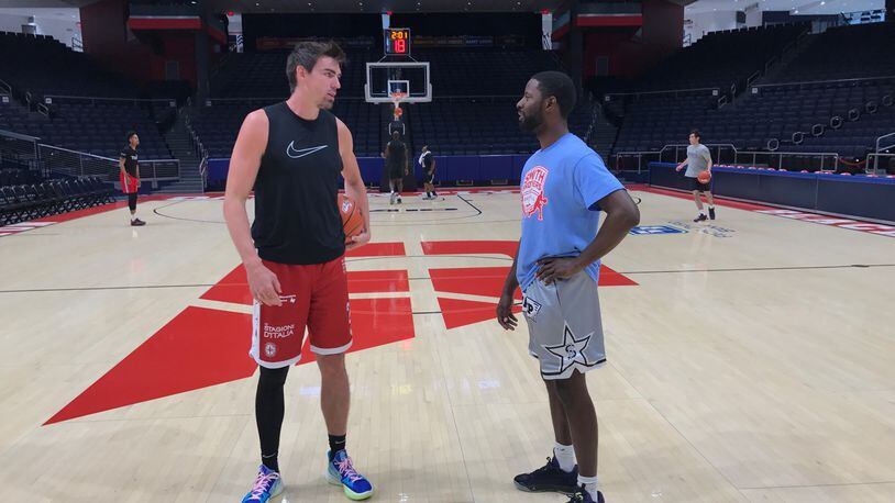 A.J. Pacher and Scoochie Smith talk near center court at UD Arena Saturday afternoon before the first TBT practice for their Red Scare team, Tom Archdeacon/CONTRIBUTED