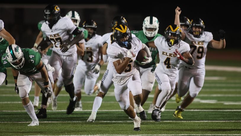 Centerville's Braylon Newcomb runs for a touchdown in the fourth quarter against Dublin Coffman on Friday, Aug. 25, 2023, at Coffman Stadium in Dublin. David Jablonski/Staff