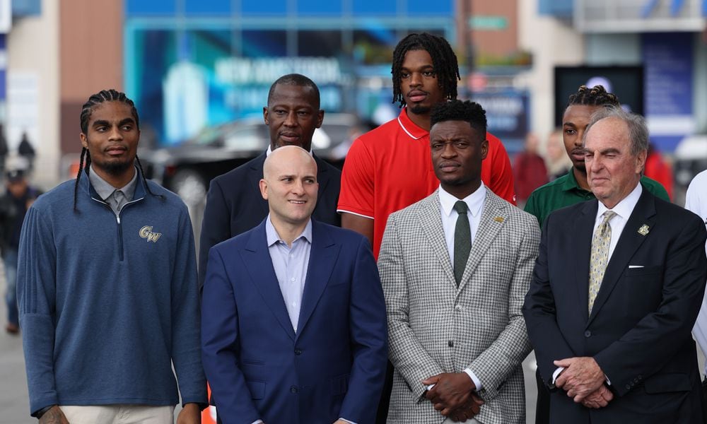 Dayton's Anthony Grant and DaRon Holmes II, back row, pose for a photo with other coaches and players at Atlantic 10 Conference Media Day on Tuesday, Oct. 17, 2023, at the Barclays Center in Brooklyn, N.Y. David Jablonski/Staff