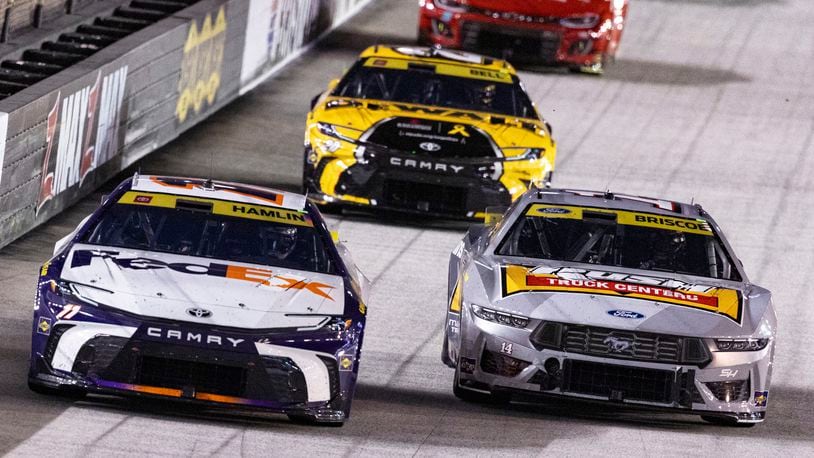 Denny Hamlin (11) leads Chase Briscoe (14) and Christopher Bell (20) during a NASCAR Cup Series auto race, Saturday, Sept. 21, 2024, in Bristol, Tenn. (AP Photo/Wade Payne)