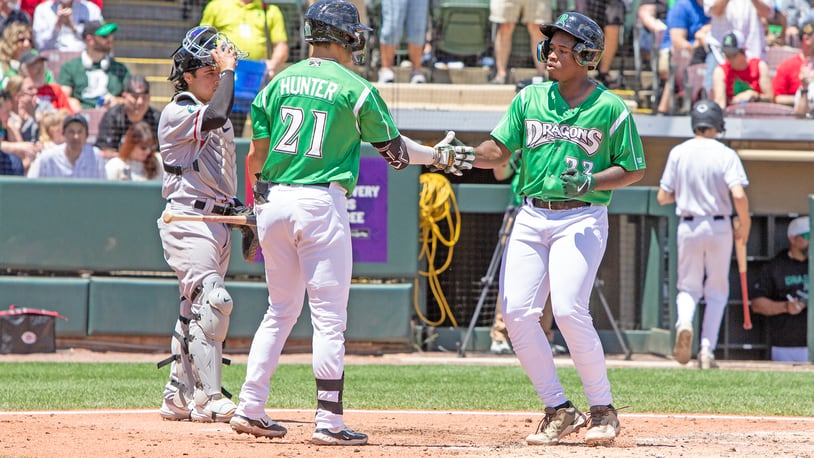 Cam Collier is greeted by Cade Hunter at home plate after hitting a home run during a game earlier this season. Jeff Gilbert/CONTRIBUTED