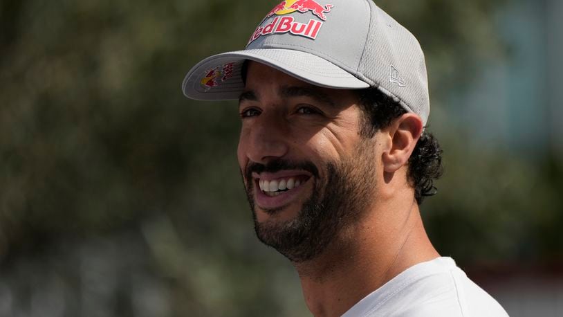 RB driver Daniel Ricciardo of Australia smiles in the paddock at the Baku circuit, in Baku, Azerbaijan, Thursday, Sept.12, 2024. The Formula One Grand Prix will be held on Sunday. (AP Photo/Sergei Grits)