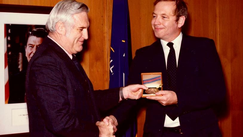 This photograph released by the CIA on behalf of the family of former CIA officer Edward B. Johnson shows Johnson, right, receiving the CIA's Intelligence Star from John N. McMahon, then the agency's deputy director for operations, in May 1980. Edward B. Johnson, who as a Central Intelligence Agency officer traveled into Iran with a colleague to rescue six American diplomats who fled the 1979 U.S. Embassy takeover in Tehran, has died, the CIA confirmed on Monday, Sept. 9, 2024. He was 81. (Family of Edward B. Johnson/CIA via AP)