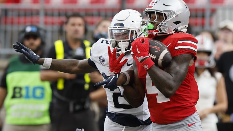 Ohio State receiver Jeremiah Smith, right, catches a pass in front of Akron defensive back Daymon David, left, during the second half of an NCAA college football game Saturday, Aug. 31, 2024, in Columbus, Ohio. (AP Photo/Jay LaPrete)