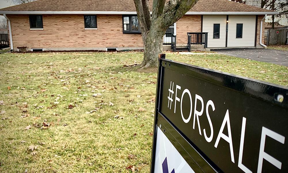 A home for sale on Bellefontaine Road in Huber Heights Wednesday, Nov. 22, 2023. The amount of homes sold each month continues to trend down through October compared to year-to-date numbers through October 2022, while the average home sale price continues to rise. MARSHALL GORBY/STAFF