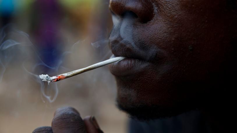 FILE - A young man smokes Kush, a derivative of cannabis mixed with synthetic drugs like fentanyl and tramadol and chemicals like formaldehyde, at a hideout in Freetown, Sierra Leone, April 29, 2024. Traces of highly potent opioids known as nitazenes have for the first time been found to be consumed by people who use drugs in Africa, according to a report released Wednesday, June 12, 2024, by the Global Initiative Against Transnational Organized Crime nonprofit. (AP Photo/ Misper Apawu, File)