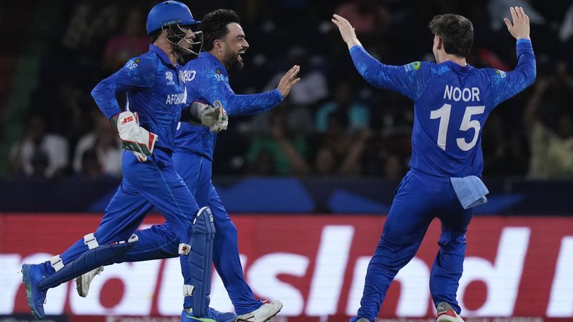 Afghanistan's captain Rashid Khan, centre, celebrates the wicket of Australia's Matthew Wade during the men's T20 World Cup cricket match between Afghanistan and Australia at Arnos Vale Ground, Kingstown, Saint Vincent and the Grenadines, Saturday, June 22, 2024. (AP Photo/Ramon Espinosa)