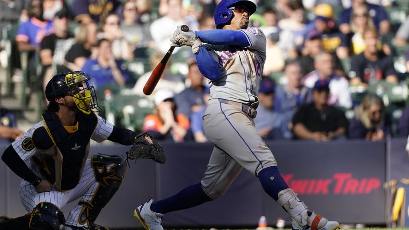 New York Mets' Francisco Lindor hits a solo home run during the sixth inning of a baseball game against the Milwaukee Brewers, Sunday, Sept. 29, 2024, in Milwaukee. (AP Photo/Aaron Gash)