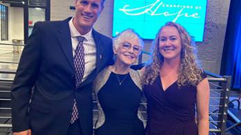 Jan Hillman (center) with Dino Dimitrouleas and Elesha Snyder, co-founder and vice chair of Breast Wishes Foundation