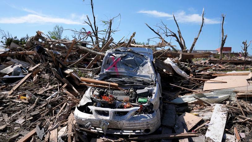 FILE - A tornado damaged car sits in a pile of debris, Thursday, May 23, 2024, in Greenfield, Iowa. Experts say that planning is key before a tornado threatens. They say weather radios, basements and bicycle helmets all save lives. Record warmth this winter provided the fuel for a deadly tornado outbreak across parts of the Midwest and South in March. (AP Photo/Charlie Neibergall, File)