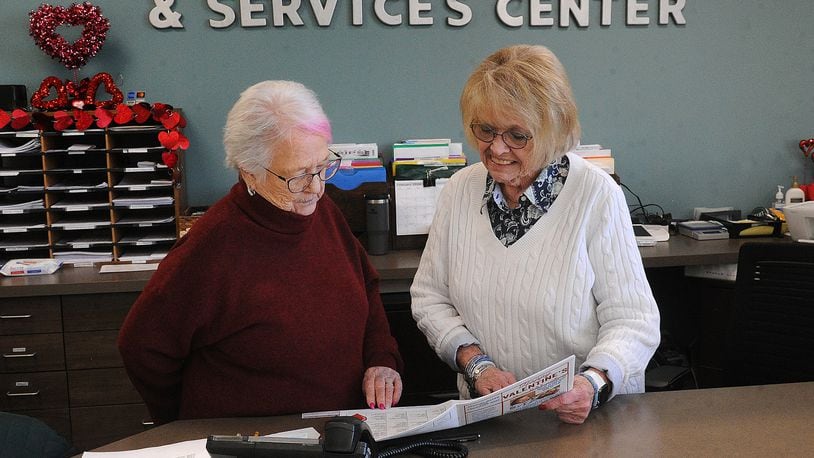 Linda Williamson, Program Manager, left, and Caroyn Pitstick, Secretary for the Xenia Adult Recreation & Services Center look over this months upcoming events. MARSHALL GORBY\STAFF